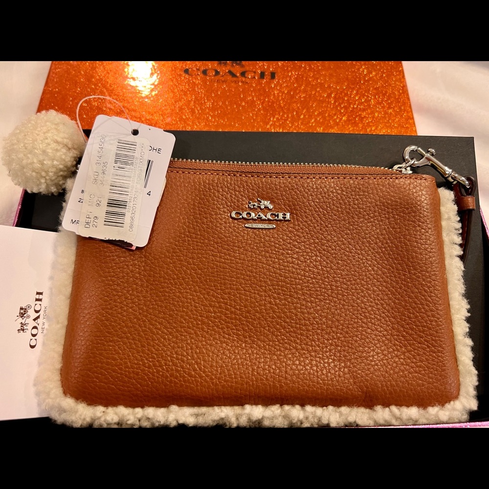 Coach wristlet new with tags. Tan color